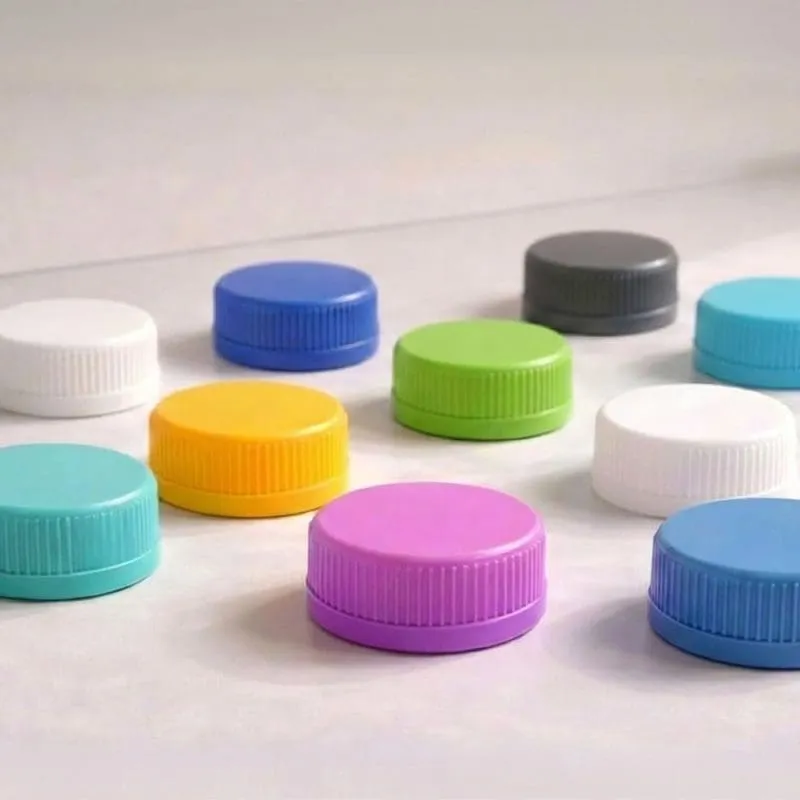 Colourful plastic bottle caps on a light surface.