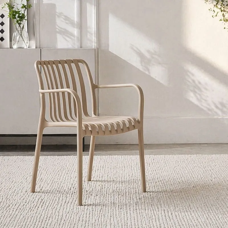 A beige chair on a light rug in a bright room.